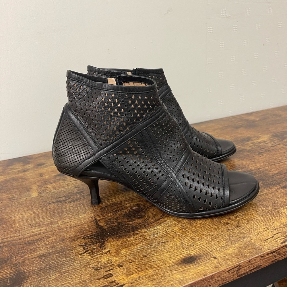Black Perforated kitten heel open toe ankle boots.